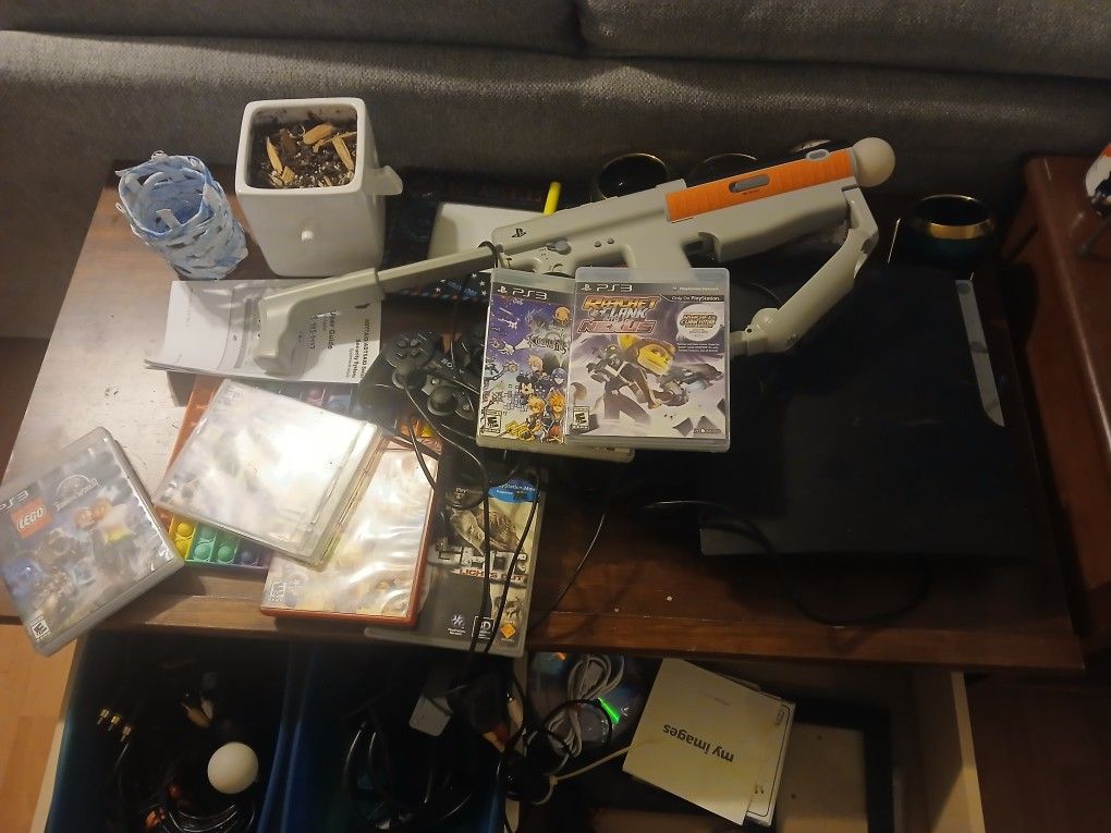 Ps3 With A Bunch Of Games And Controllers