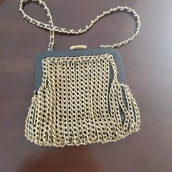 Michael Kors designer clutch purse bag with a metallic gold mesh body and a chain strap