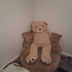 A Big Teddy 4 Pairs Of Boots A Couch