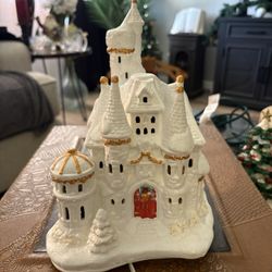 Walt Disney Princess Belle's Castle Snow Village" collectible, likely produced by Brass Key Keepsakes.  This is a lighted castle figurine, designed as