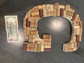 G letter covered with wine corks