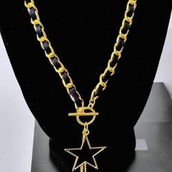 Gold tone star pendant necklace with black chain and lobster clasp