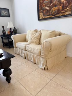 Cream Slipcovered Loveseat with Throw Pillows