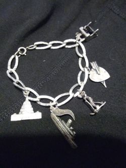 Vintage silver bracelet with various pendants $50