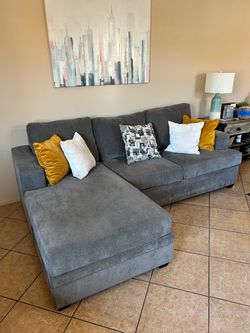 DELIVERY AVAILABLE 🚛… Gorgeous grey sectional couch with reversible chaise from Living Spaces