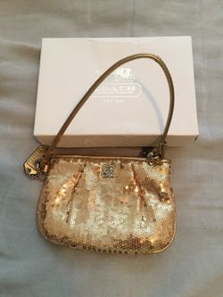 Small gold coach wristlet
