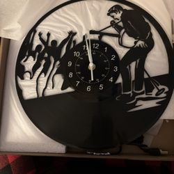 Elvis vinyl record wall clock featuring a jazz or rock music performance silhouette design