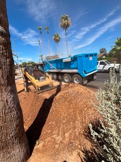 Skid steer and dump truck