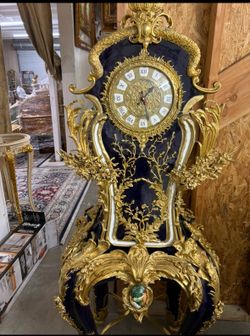 Ornate French Clock LOOK UP An ornate French-style ornamental mantel clock with gold gilt and blue enamel. TIME PERIOD Late 19th Century ORIGIN France
