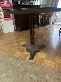 28” Tall,  36” diameter Glass Top Table.  Heavy Vintage  Cast Iron Base