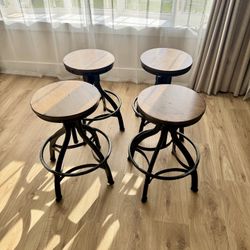 Distressed Black Metal Adjustable Height Backless Swivel Stool (set of 4)