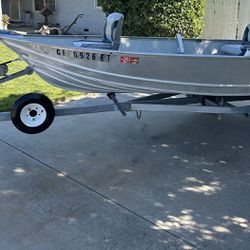 12’3” Gregor Aluminum Fishing Boat and Trailer with A Johnson 15 Horsepower Two Stroke Motor
