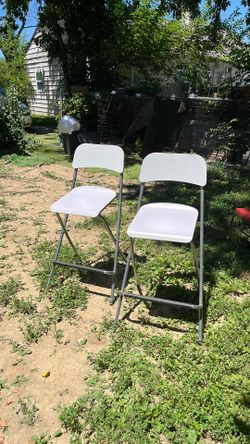 Two Nice tall white fold up chairs