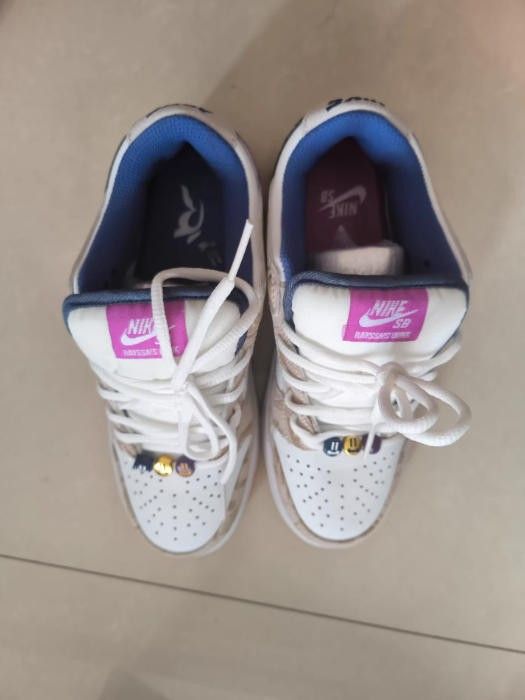 Nike men's shoes come in a classic purple and white color scheme. Bottom of the shoe is made of beige rubber
