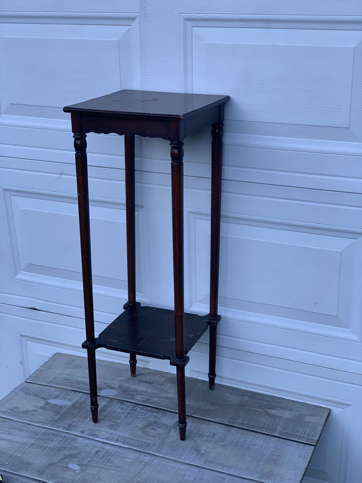 Vintage 1999 Bombay Company mahogany wood 2-tier plant stand in fair condition. Top and shelf show water bubbles and wear as shown. Measures 35.5” tal