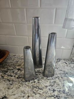 Three gray candle holders