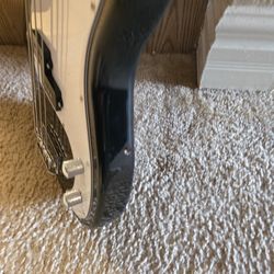 Base guiter, small amplifier,and stand.