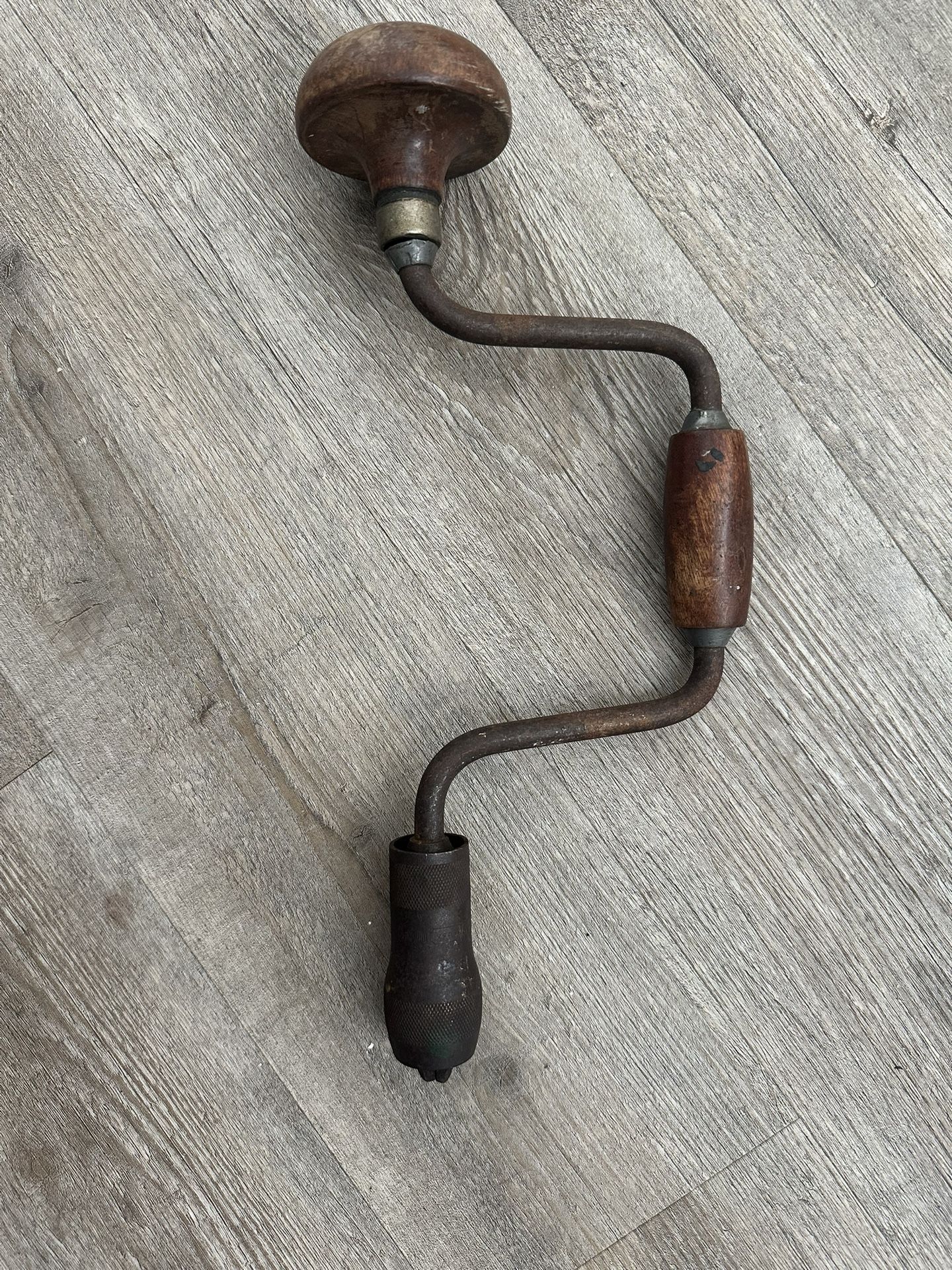 antique brace and bit hand drill. It's a manual drilling tool, often used for woodworking