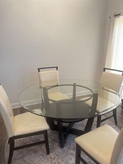 Espresso table with glass top with four cream and espresso chairs