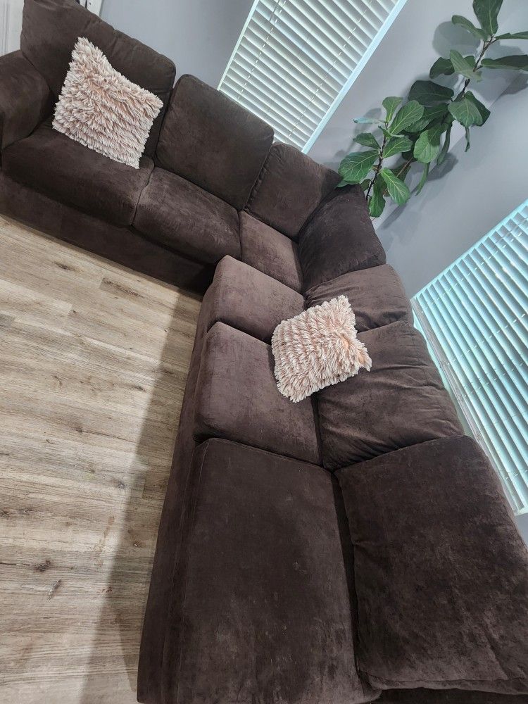 Brown sectional (the light is hitting the couch thats why it looks lighter in 2 sections)