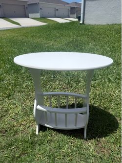 Selling a white corner table with magazine rack.