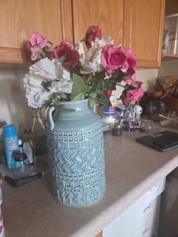 Large vase with fake roses.