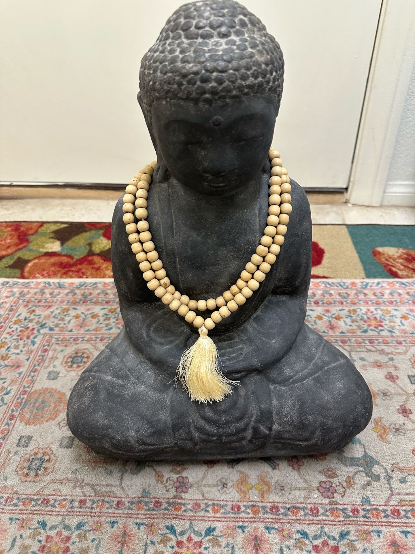 Seated Buddha with beads