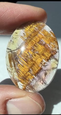 Cacoxenite in Quartz Cabochon with Amethyst