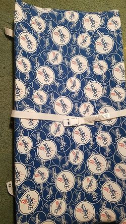Changing table pad covered in dodger material