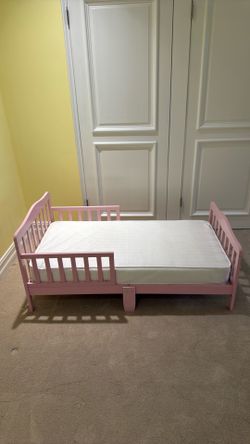 Pink child’s bed with Sealy mattress