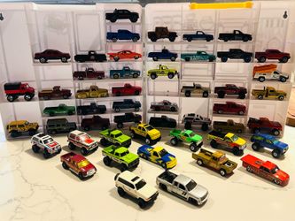 54 loose diecast toy trucks and SUVs from brands like Hot Wheels and Matchbox.Vehicle Variety: The set includes various models of trucks, vans, and SU
