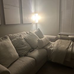 Beige Sectional With Pillows And Blanket 