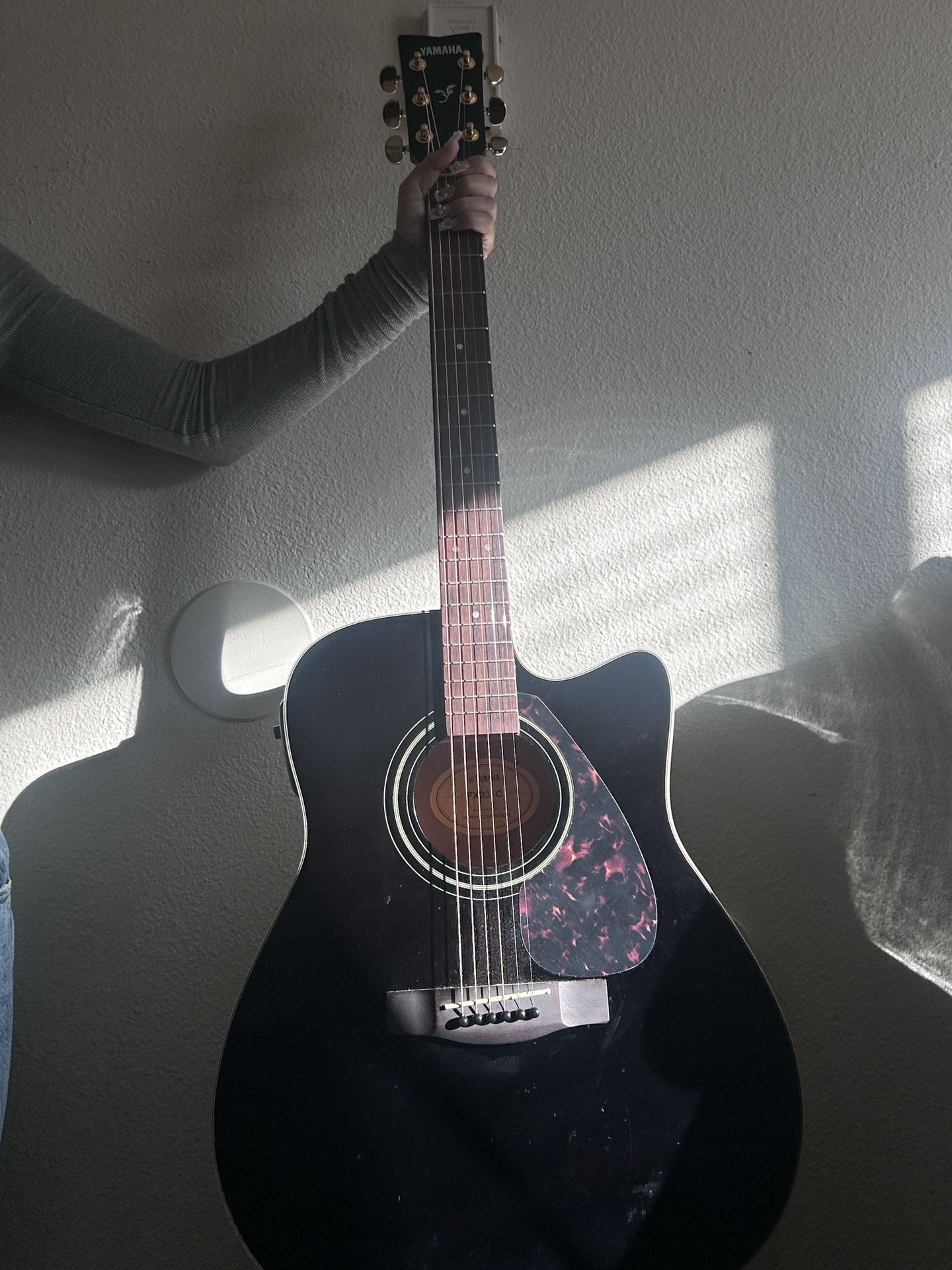 Black Yamaha 6 string acoustic/electric guitar