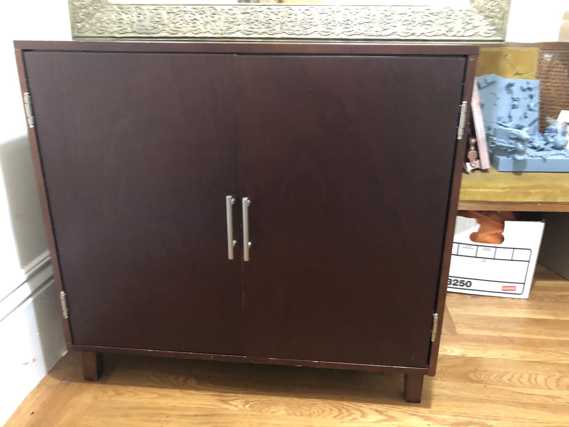 Dark brown storage cabinet with adjustable shelf and drawer