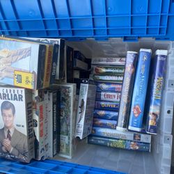 Two large tubs, full of VHS and DVDs quite a few Disney