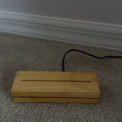 Wooden Light Dock Beige Wood Design That Fits A Plastic Piece In The Center, The Dock Lights The Plastic Piece Up