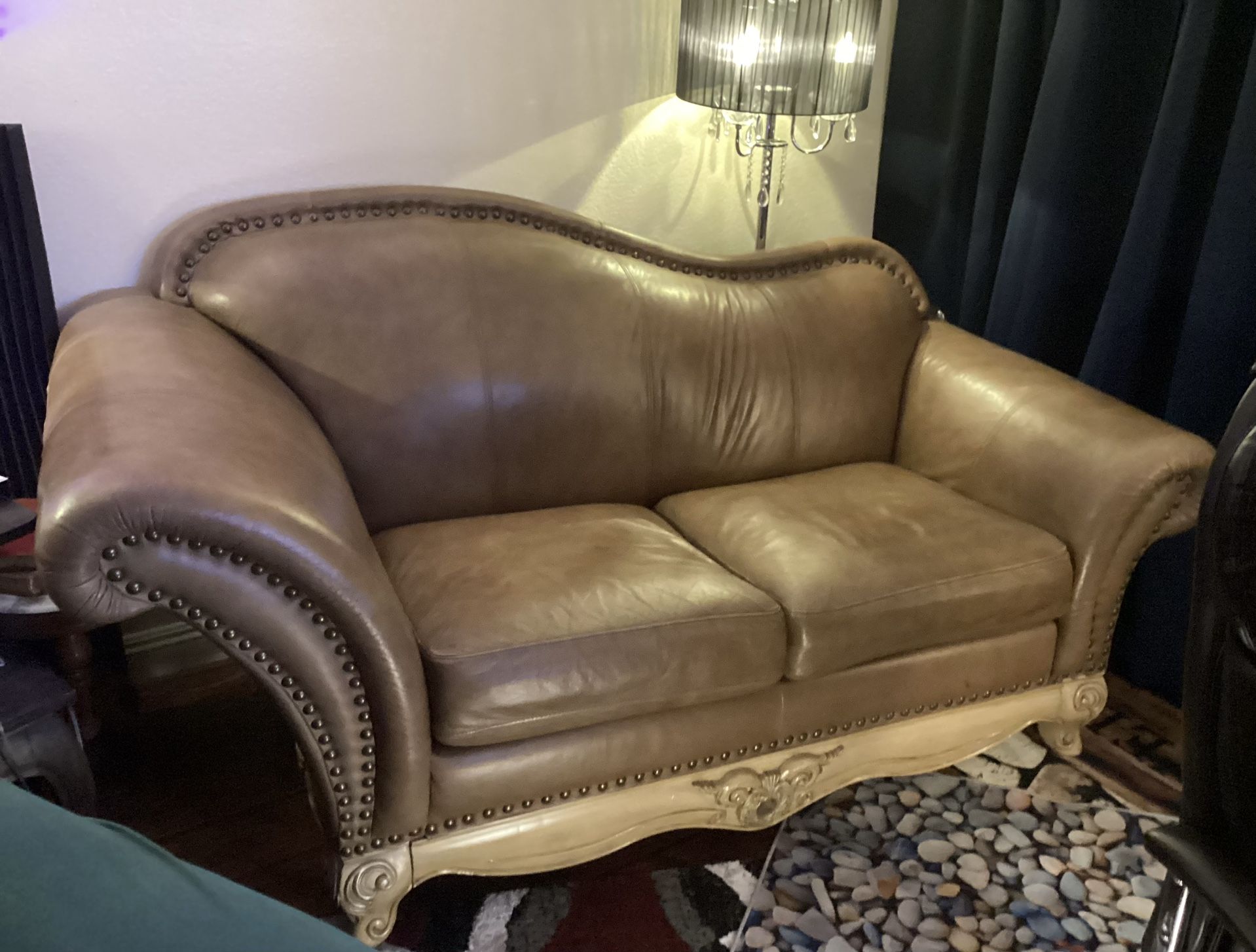 Luxury Leather Loveseat on an Ornate Wood Base.