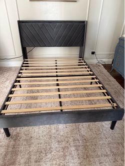 Gray queen bed with charging ports on top