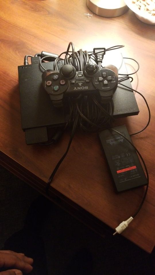 PlayStation 2 with 13 games and one xbox 360 game (COD MW2) Cords included