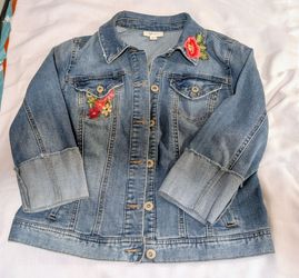 Style & Co embroidered denim jacket is a vintage-inspired piece known for its floral appliqués and classic trucker silhouette.