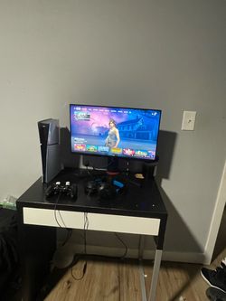 PlayStation 5 Console with Monitor and Controller and desk