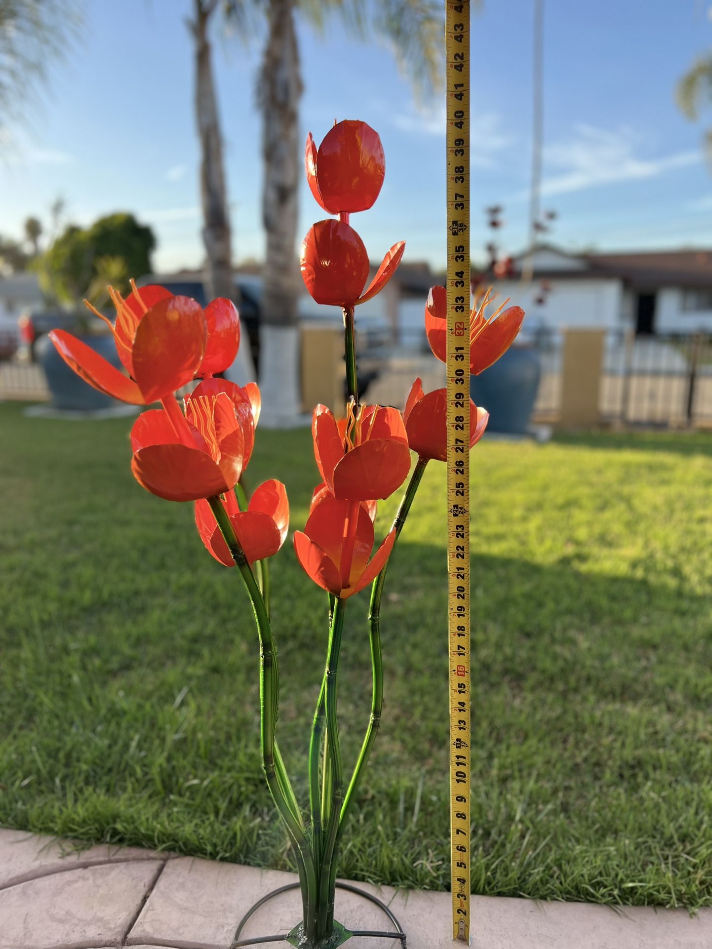  Iron hand-welded made orange tulips with green stems and a circular base for stability. designed for yard or garden decor.