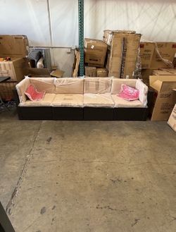 Beige Outdoor Wicker Sofa w/ Two Red Pillows