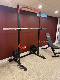 Squat Rack With Rubber Plates Barbell And Bench