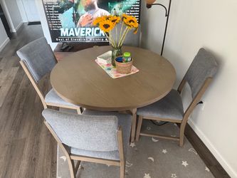 5-piece round wood dining set with grey upholstered chairs