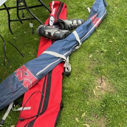 2 Sets Of Skis And A Pair Of Ski Boots