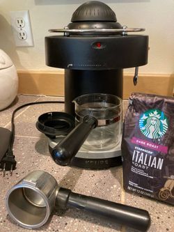 Krups XP1000 Solo Steam Espresso Machine featuring a black finish, 4-bar pressure, and a glass carafe.