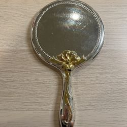 VTG silver tone handheld mirror with gold floral handle