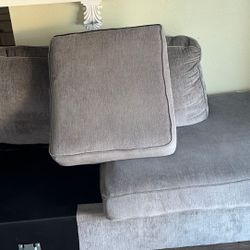 L-shaped grey armchairs