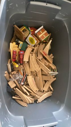 Box of toy trains and tracks